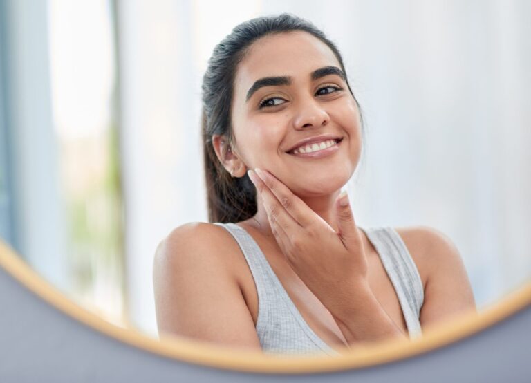 Client touching a smooth cheek after treatment