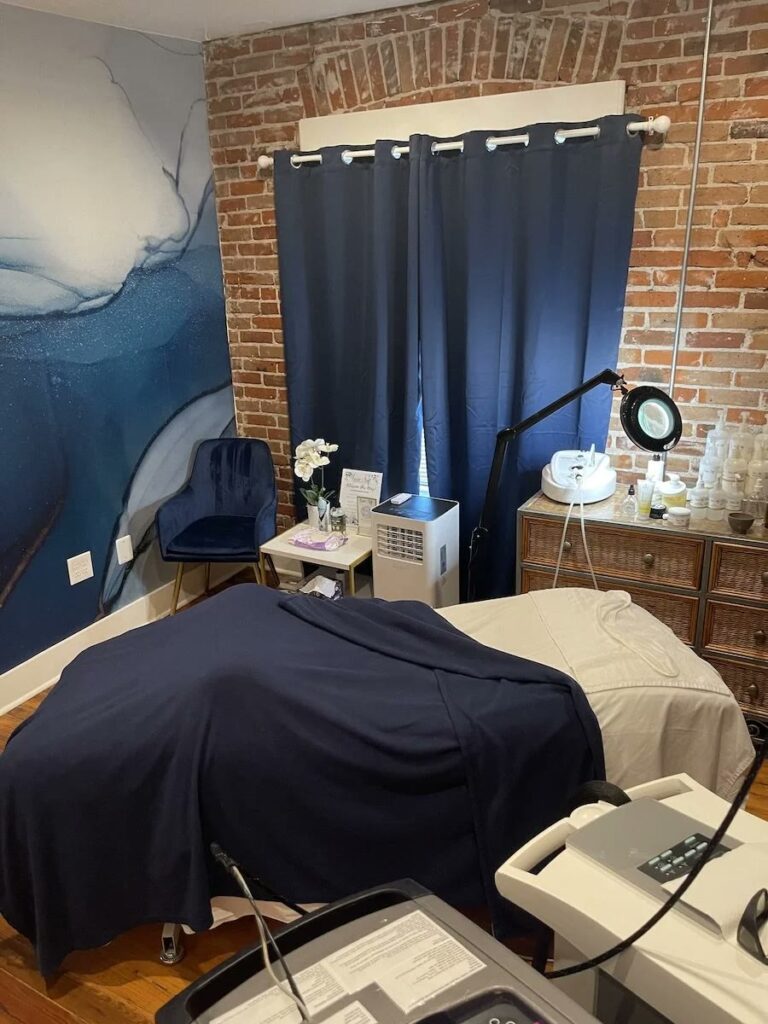 A Denver treatment room with navy curtains and the blue chair